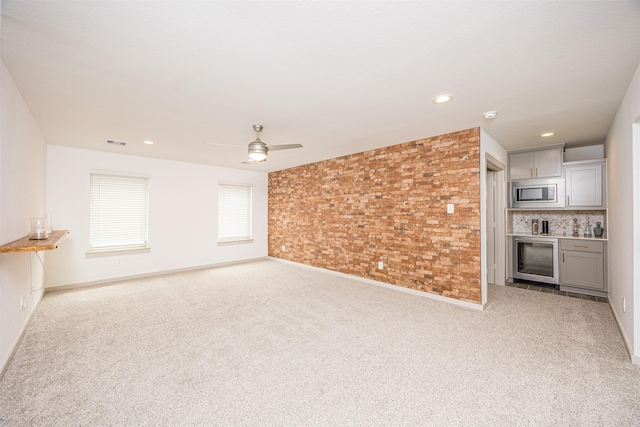 3330 Black Gore Creek Dr, Katy, TX 77494 - unfurnished living room with carpet, ceiling fan, baseboards, recessed lighting, and brick wall