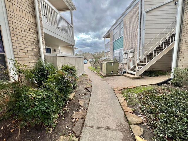 12660 Ashford Point Dr Unit 811, Houston, TX 77082 - view of yard with central AC unit and stairway
