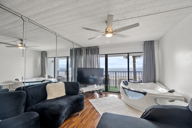 7310 Seawall Blvd Unit 309, Galveston, TX 77551 - living room with a ceiling fan, a textured ceiling, and wood finished floors