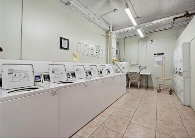 7310 Seawall Blvd Unit 309, Galveston, TX 77551 - community laundry featuring independent washer and dryer, light tile patterned flooring, stacked washer / drying machine, and a garage