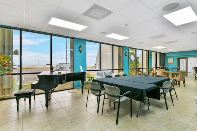 7310 Seawall Blvd Unit 309, Galveston, TX 77551 - tiled dining room featuring a wall of windows and a paneled ceiling