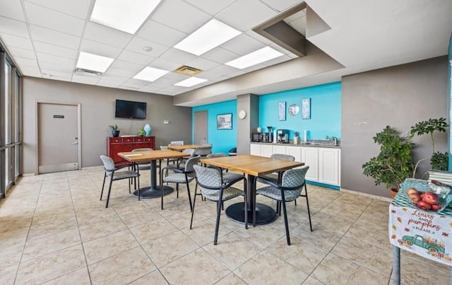 7310 Seawall Blvd Unit 309, Galveston, TX 77551 - dining space featuring light tile patterned floors, a paneled ceiling, and baseboards