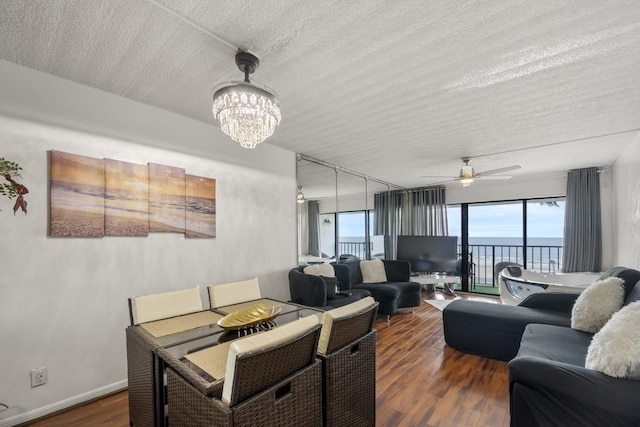 7310 Seawall Blvd Unit 309, Galveston, TX 77551 - living area with dark wood-style floors, a chandelier, a textured ceiling, and ceiling fan