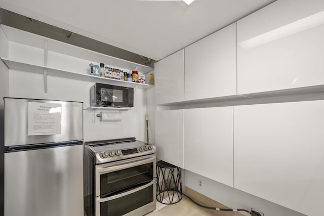 7310 Seawall Blvd Unit 309, Galveston, TX 77551 - kitchen with appliances with stainless steel finishes and white cabinets