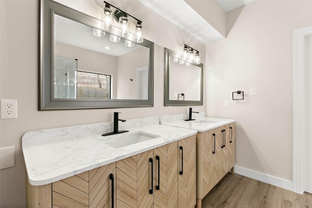 17819 Forest Park Ln, Spring, TX 77379 - full bathroom featuring double vanity, wood finished floors, a shower, and baseboards