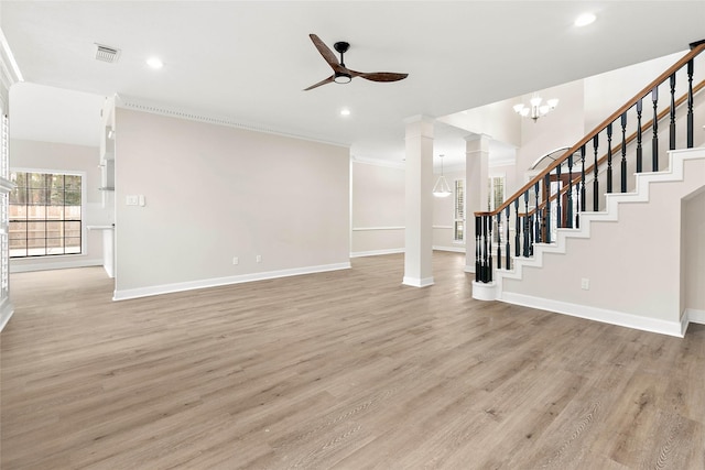 17819 Forest Park Ln, Spring, TX 77379 - unfurnished living room featuring ornate columns, stairs, light wood finished floors, a ceiling fan, and crown molding