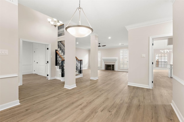 17819 Forest Park Ln, Spring, TX 77379 - unfurnished living room with a chandelier, stairs, baseboards, light wood-type flooring, and ornamental molding