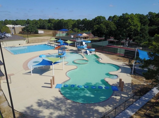 17819 Forest Park Ln, Spring, TX 77379 - community pool with a water play area, a water slide, view of wooded area, and a patio