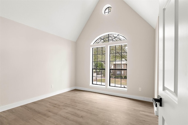17819 Forest Park Ln, Spring, TX 77379 - empty room featuring wood finished floors, high vaulted ceiling, and baseboards