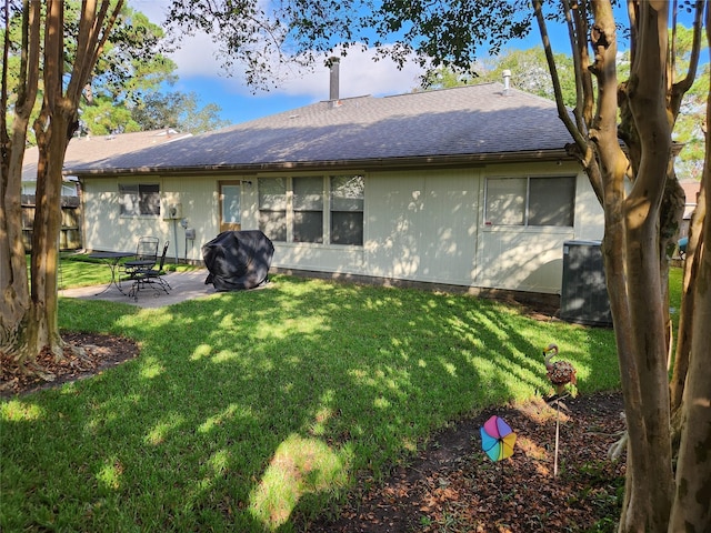 5515 Pimberton Ln, Spring, TX 77379 - back of house with a shingled roof, a patio, and a lawn