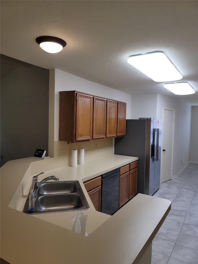 5515 Pimberton Ln, Spring, TX 77379 - kitchen with a sink, black dishwasher, stainless steel fridge, a peninsula, and light countertops