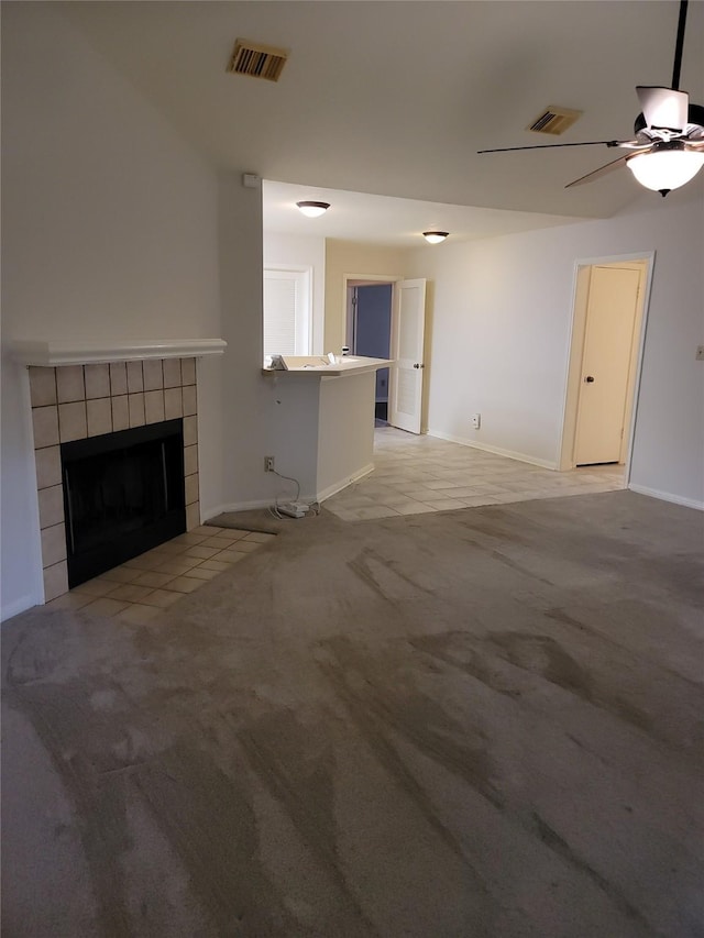 5515 Pimberton Ln, Spring, TX 77379 - unfurnished living room with a tiled fireplace, carpet flooring, ceiling fan, and baseboards
