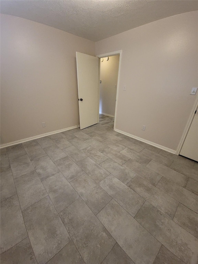 5515 Pimberton Ln, Spring, TX 77379 - spare room with baseboards and a textured ceiling