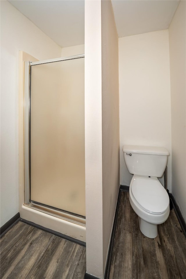 1933 Fm 1272, Grapeland, TX 75844 - bathroom featuring wood finished floors, a shower stall, and toilet