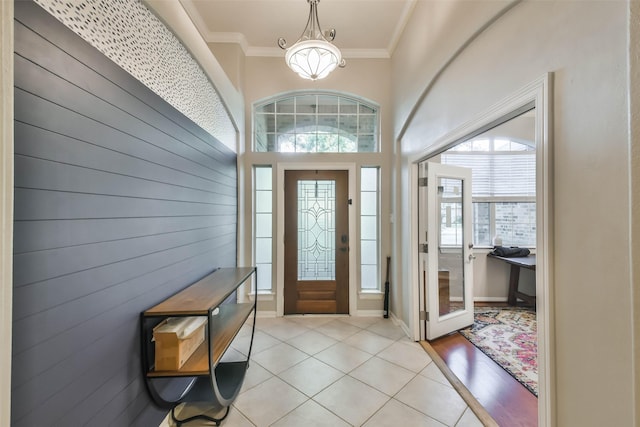 12202 Salt River Valley Ln, Humble, TX 77346 - entrance foyer with ornamental molding, light tile patterned floors, and baseboards