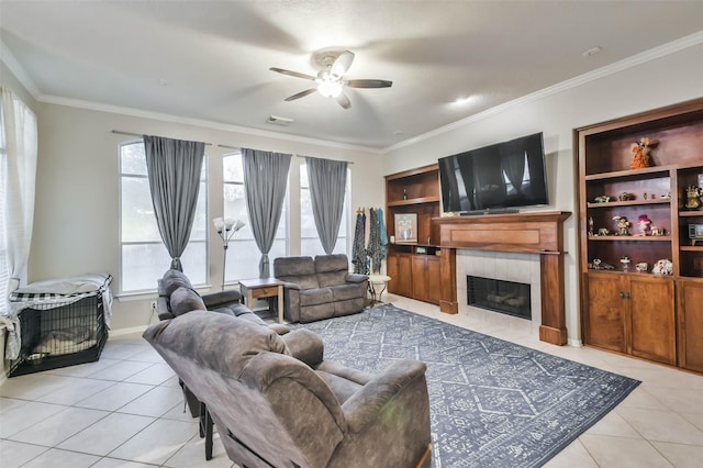 12202 Salt River Valley Ln, Humble, TX 77346 - living area featuring light tile patterned flooring, a ceiling fan, crown molding, and a tiled fireplace