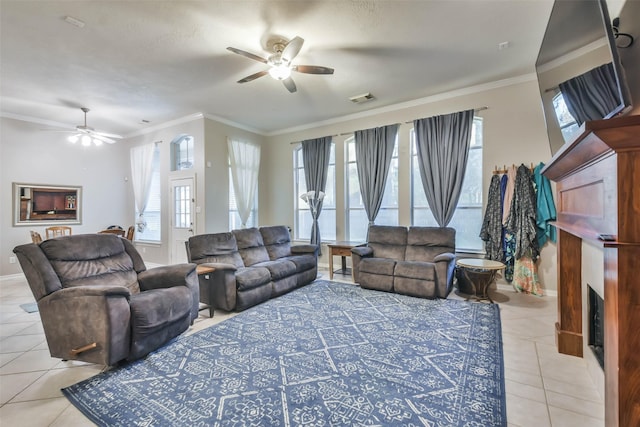 12202 Salt River Valley Ln, Humble, TX 77346 - living area with ceiling fan, light tile patterned floors, a fireplace, crown molding, and baseboards