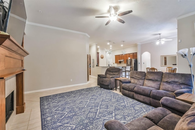 12202 Salt River Valley Ln, Humble, TX 77346 - living area featuring a ceiling fan, light tile patterned flooring, a fireplace, ornamental molding, and baseboards