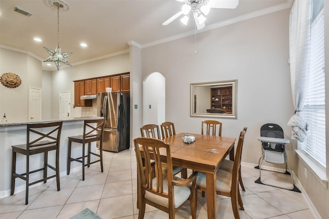 12202 Salt River Valley Ln, Humble, TX 77346 - dining space featuring arched walkways, ceiling fan, light tile patterned floors, ornamental molding, and recessed lighting