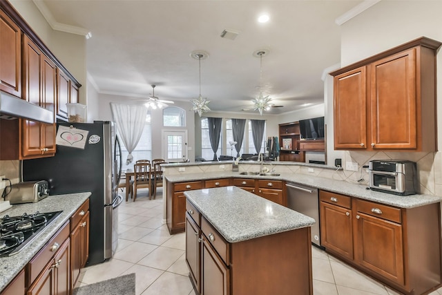 12202 Salt River Valley Ln, Humble, TX 77346 - kitchen featuring a ceiling fan, stainless steel appliances, a sink, ornamental molding, and decorative backsplash
