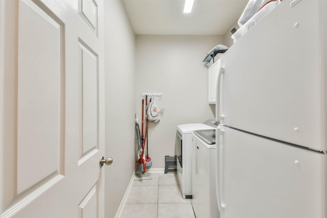 12202 Salt River Valley Ln, Humble, TX 77346 - laundry area with light tile patterned floors, cabinet space, independent washer and dryer, and baseboards