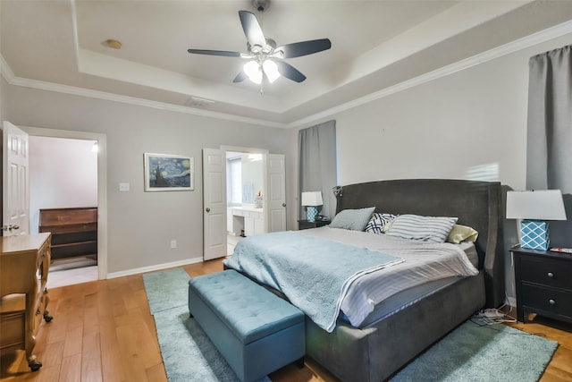 12202 Salt River Valley Ln, Humble, TX 77346 - bedroom with a raised ceiling, light wood finished floors, baseboards, ornamental molding, and ceiling fan