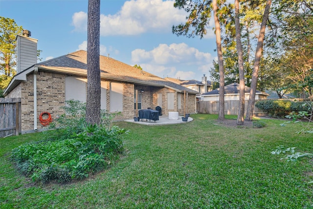 12202 Salt River Valley Ln, Humble, TX 77346 - rear view of property featuring a chimney, brick siding, and a patio area