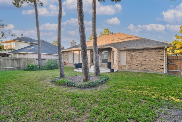 12202 Salt River Valley Ln, Humble, TX 77346 - rear view of house with a patio, brick siding, and a shingled roof