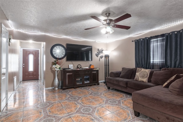 14914 Lawther St, Channelview, TX 77530 - living area featuring a textured ceiling, a ceiling fan, and baseboards