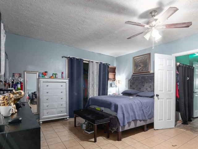 14914 Lawther St, Channelview, TX 77530 - bedroom with tile patterned flooring, a textured ceiling, and ceiling fan