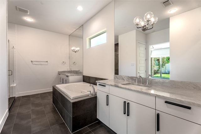 11502 Royal Tower Pl, Houston, TX 77082 - full bath featuring a chandelier, two vanities, plenty of natural light, a garden tub, and recessed lighting