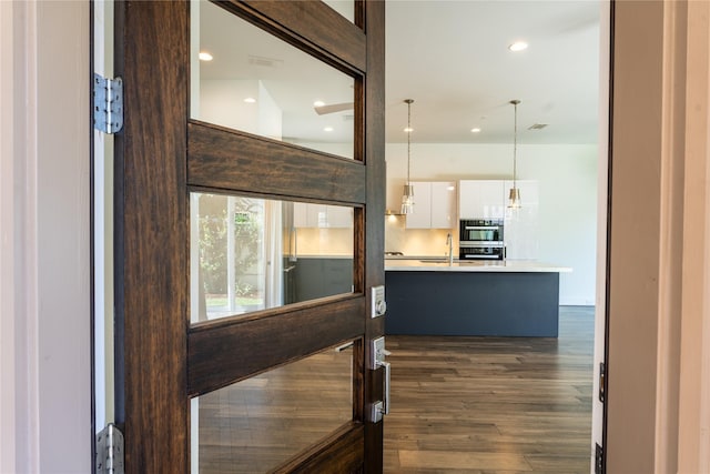 11502 Royal Tower Pl, Houston, TX 77082 - corridor with dark wood-style flooring and recessed lighting