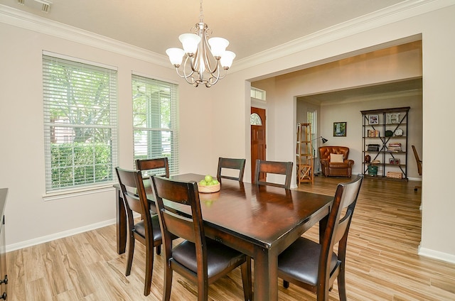 4134 Foxbrush Ln, Sugar Land, TX 77479 - dining space featuring a chandelier, crown molding, healthy amount of natural light, light wood finished floors, and baseboards