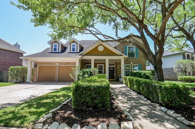 4134 Foxbrush Ln, Sugar Land, TX 77479 - traditional home featuring concrete driveway, brick siding, an attached garage, and covered porch