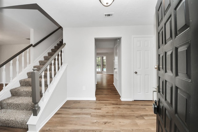 7622 Shangrila Ln, Houston, TX 77095 - foyer entrance with light wood-type flooring, stairway, and baseboards