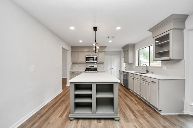 7622 Shangrila Ln, Houston, TX 77095 - kitchen featuring stainless steel appliances, gray cabinetry, open shelves, light wood-style flooring, and recessed lighting