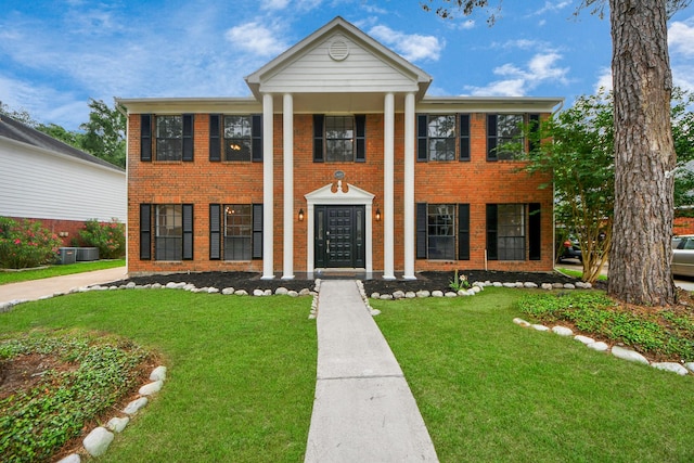 7622 Shangrila Ln, Houston, TX 77095 - neoclassical / greek revival house featuring brick siding, a front yard, and central AC
