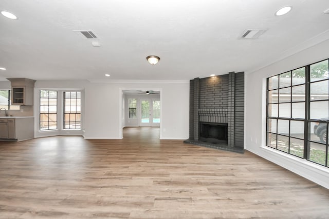 7622 Shangrila Ln, Houston, TX 77095 - unfurnished living room with crown molding, a ceiling fan, healthy amount of natural light, a brick fireplace, and recessed lighting