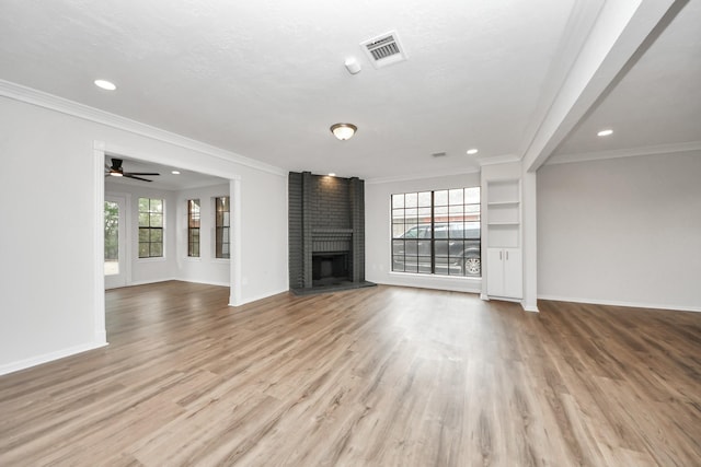 7622 Shangrila Ln, Houston, TX 77095 - unfurnished living room with healthy amount of natural light, baseboards, wood finished floors, a brick fireplace, and recessed lighting