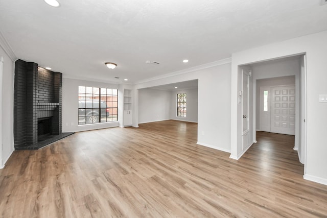7622 Shangrila Ln, Houston, TX 77095 - unfurnished living room featuring baseboards, light wood-type flooring, a fireplace, crown molding, and recessed lighting