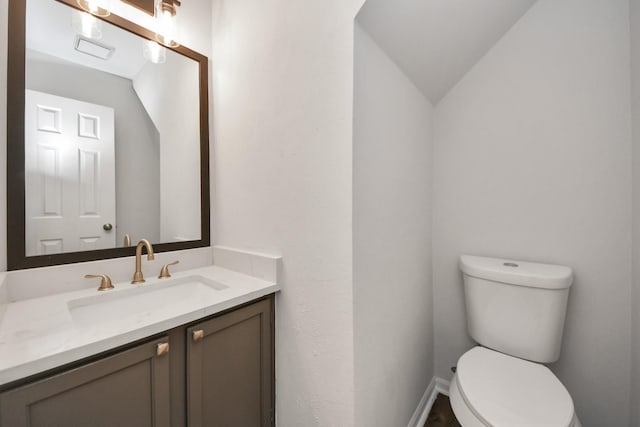 7622 Shangrila Ln, Houston, TX 77095 - half bath featuring vanity, toilet, vaulted ceiling, and baseboards