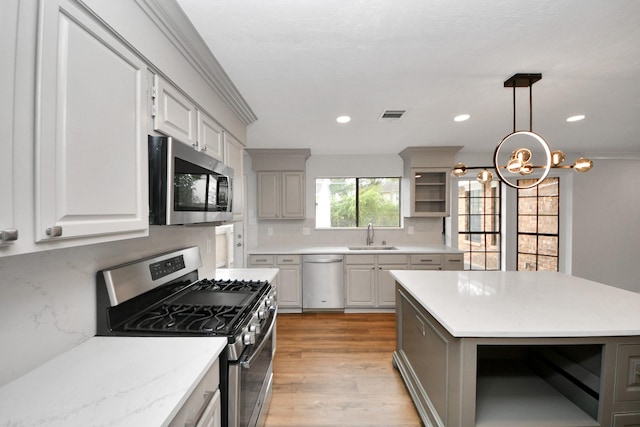 7622 Shangrila Ln, Houston, TX 77095 - kitchen featuring stainless steel appliances, light wood finished floors, tasteful backsplash, decorative light fixtures, and a chandelier