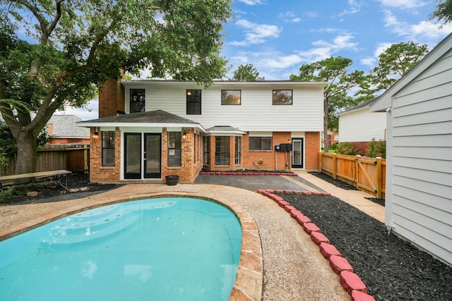 7622 Shangrila Ln, Houston, TX 77095 - back of house featuring brick siding, a fenced backyard, and a patio