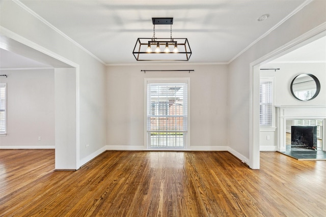 6649 Fairfield St, Houston, TX 77023 - unfurnished living room featuring wood finished floors, baseboards, ornamental molding, and a tile fireplace