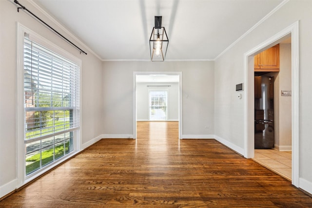 6649 Fairfield St, Houston, TX 77023 - unfurnished dining area with crown molding, wood finished floors, and baseboards