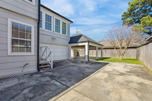 6649 Fairfield St, Houston, TX 77023 - view of home's exterior with asphalt driveway, a garage, a carport, and entry steps