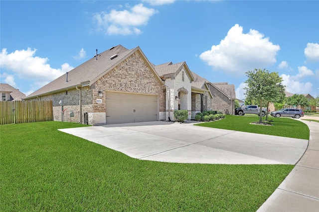 28111 Middlewater View Ln, Katy, TX 77494 - french country home with brick siding, driveway, an attached garage, and roof with shingles