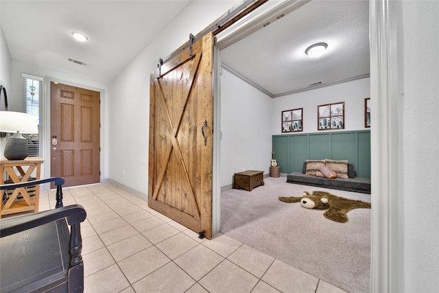 28111 Middlewater View Ln, Katy, TX 77494 - foyer with a barn door, tile patterned flooring, and baseboards
