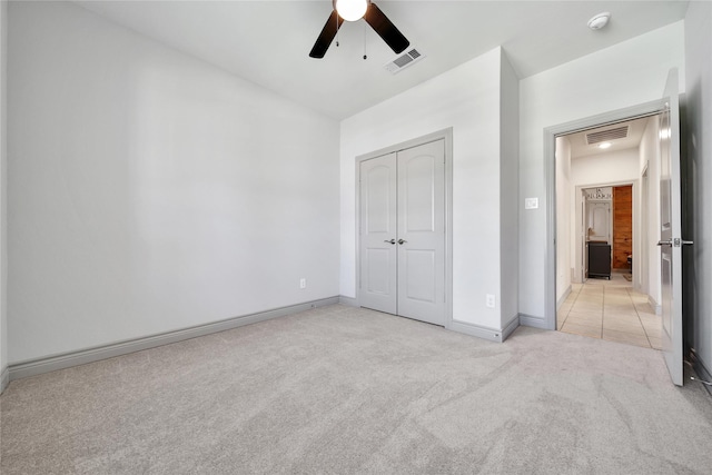 28111 Middlewater View Ln, Katy, TX 77494 - unfurnished bedroom with light carpet, a closet, baseboards, and ceiling fan