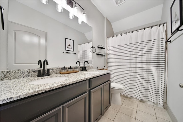 28111 Middlewater View Ln, Katy, TX 77494 - full bathroom featuring double vanity, tile patterned flooring, toilet, lofted ceiling, and a shower with shower curtain